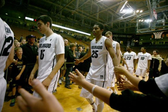 Guard Spencer Dinwiddie high fives fans while leaving the court Saturday after Colorado's 94-70 win over Jackson State. Dinwiddie finished with 11 points. (James Bradbury/CU Independent)