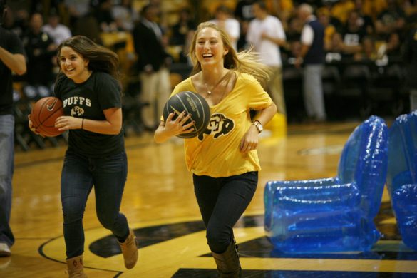 Senior psychology student Paige Banks competes in "musical chairs" during halftime. (James Bradbury/CU Independent)
