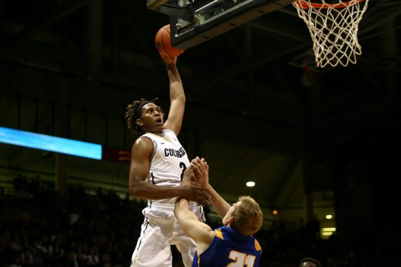 Sophomore forward Xavier Johnson (2) skies for a dunk over UCSB's Mitch Brewe (21). (Kai Casey/CU Independent)
