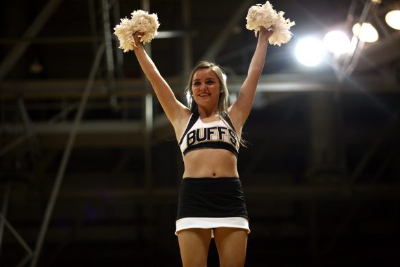 A CU cheerleader pumps up the crowd during a men's NCAA basketball game, Thursday, Nov. 21, 2013, at the Coors Events Center in Boulder, Colo. (Kai Casey/CU Independent)
