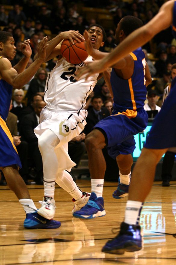 Spencer Dinwiddie (25) fights for the ball with UCSB defenders. (Kai Casey/CU Independent)