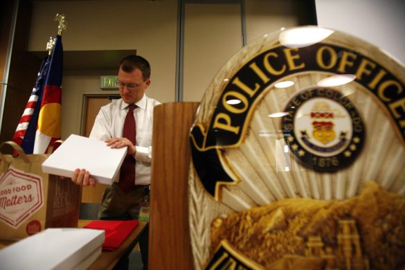 CU Police Department Spokesperson Ryan Huff looks at an award before a the ceremony on Monday. (Kai Casey/CU Independent)