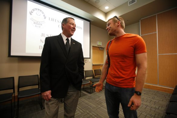 CU Police Chief Ron Burns, left, chats with Nathaniel Pohl, a residential advisor in Aden Hall, before a Lifesaving Awards ceremony, Monday, Nov. 18, 2013, in the Kittredge Central Multipurpose Room. Pohl received the Lifesaving Award, the highest CU police honor presented to the public, for saving an 80-year-old man's life with two other students in August in the Center for Community. (Kai Casey/CU Independent)