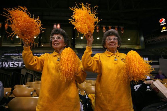 Eighty-nine-year-old twins, Betty Fitzgerald Hoover and Peggy Fitzgerald Coppom, cheer on the CU women's basketball team before a women's NCAA basketball game against Iowa, Wednesday at the Coors Events Center in Boulder, Colo. (Kai Casey/CU Independent)