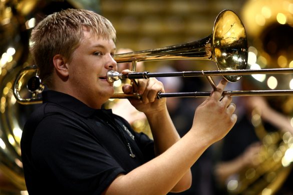 A CU band member plays the trombone before the start of the game. (Kai Casey/CU Independent)