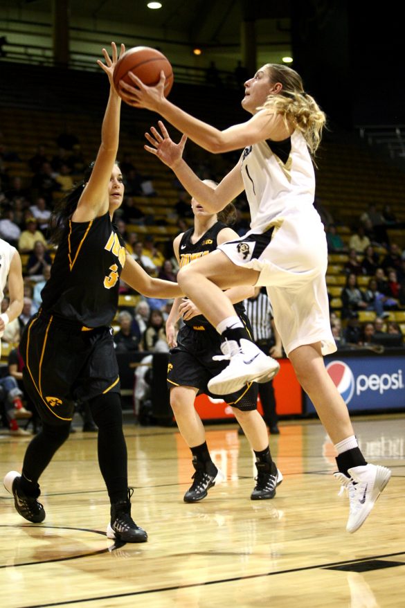 Junior guard Lexy Kresl (1) jumps for a layup past Iowa's Claire Till (3) in the second half. (Kai Casey/CU Independent)