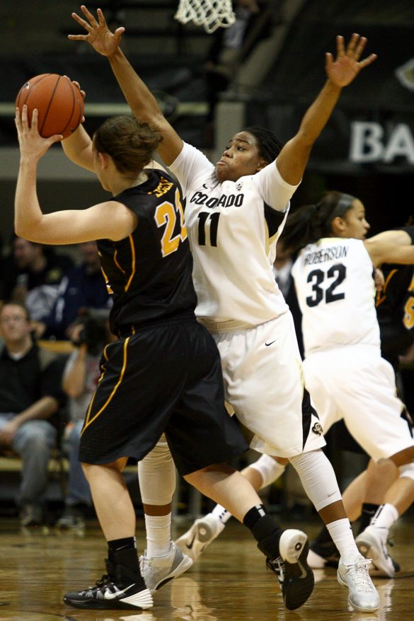 Senior guard Brittany Wilson (11) defends Iowa's Melissa Dixon (21) in the second half. Wilson was a force on defense, coming away with three steals. (Kai Casey/CU Independent)