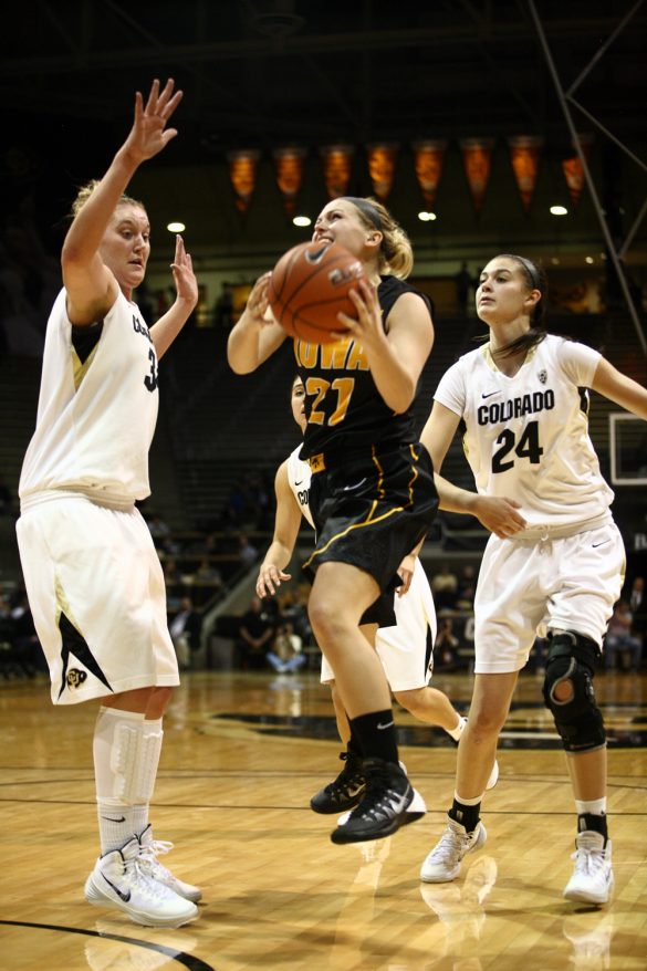 Melissa Dixon (21) attempts a layup between Jen Reese (34) and Lauren Huggins (24). The Buffs defense was fierce, forcing 20 turnovers and coming away with nine steals. (Kai Casey/CU Independent)
