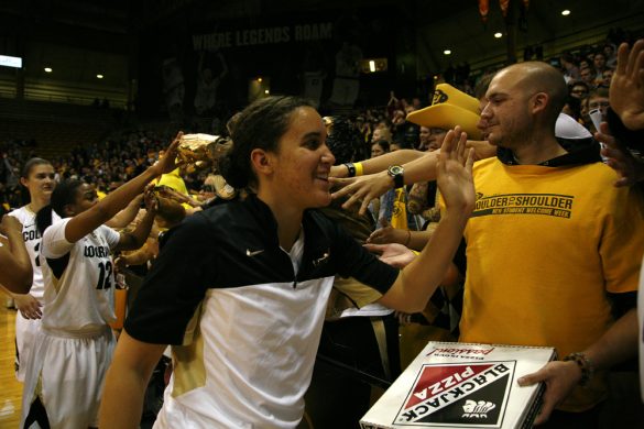 Freshman guard Haley Smith (22) high fives fans after defeating Iowa 90-87. (Kai Casey/CU Independent)