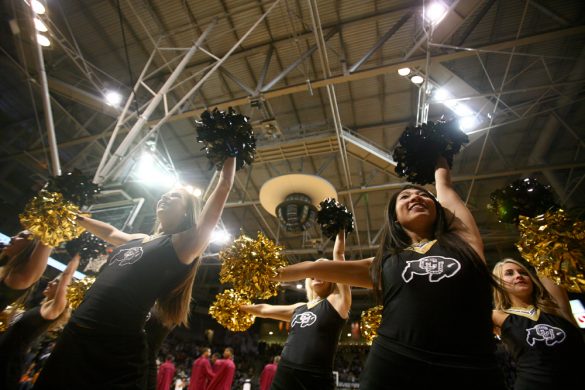 CU cheerleaders pump up the crowd before the start of the game. (Kai Casey/CU Independent)