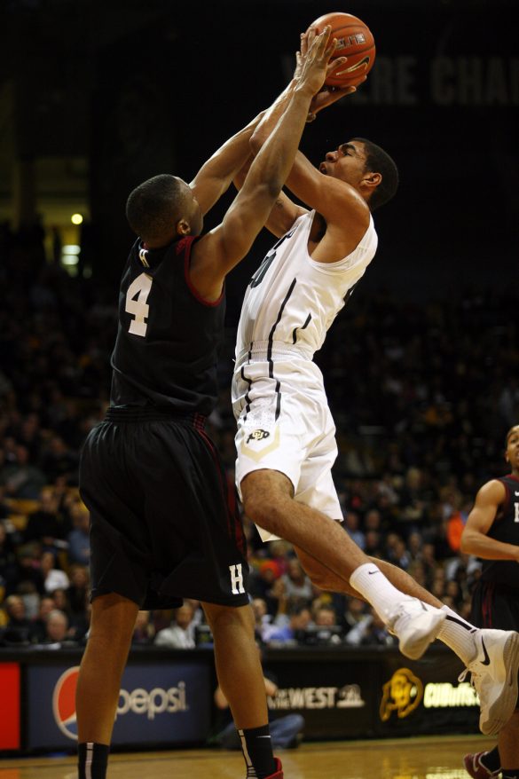 Josh Scott (40) goes in for a layup as Harvard's Zena Edosomwan (4) makes contact. (Kai Casey/CU Independent)