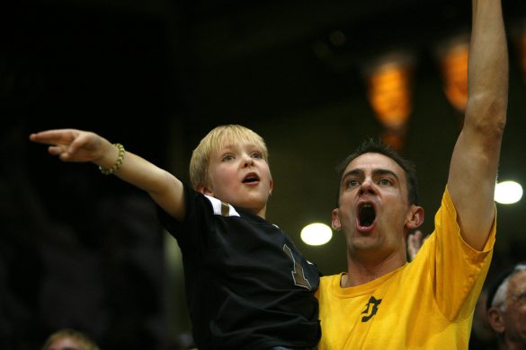 A Colorado fan and his son cheer as the Buffs start to come back. (Kai Casey/CU Independent)