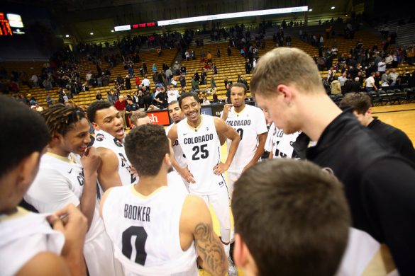 Spencer Dinwiddie (25) shares a laugh with his team after they defeated Harvard 70-62. (Kai Casey/CU Independent)