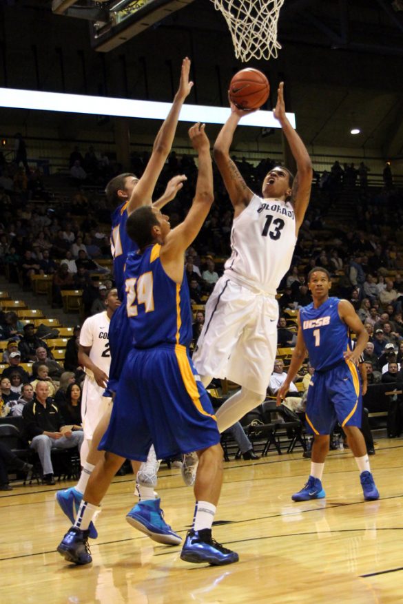 Dustin Thomas (13) takes a fade-away jumper against two UCSB defenders. (Gray Bender/CU Independent)