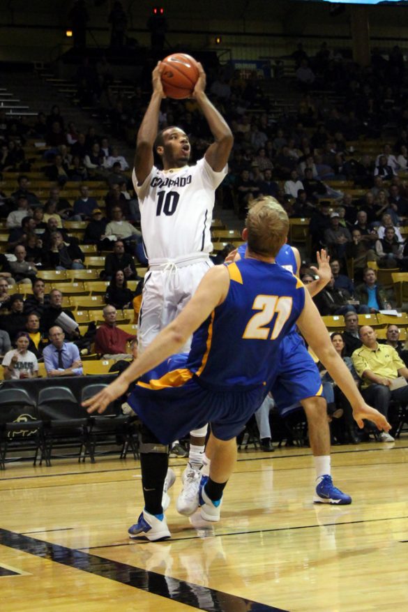 TreShaun Fletcher (10) takes a shot as Mitch Brewe (21) of UCSB tries to take a charge. (Gray Bender/CU Independent)