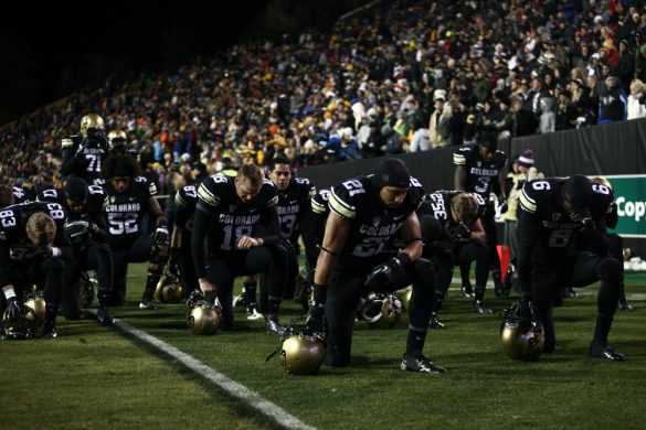 Buff players take a knee in the endzone before the start of the game. (James Bradbury/CU Independent)
