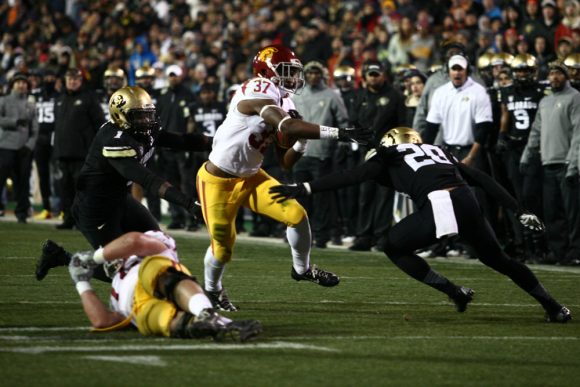 Sophomore tailback Javorius Allen (37) slips between Colorado's Derrick Webb (1) and Greg Henderson (20) on his way to a touchdown to put USC up 7-0. (James Bradbury/CU Independent)