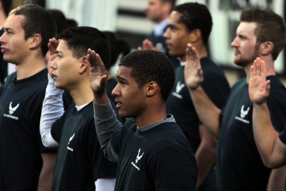 New recruits take the Oath of Enlistment to enter various military branches after the first quarter. (Matt Sisneros/CU Independent)