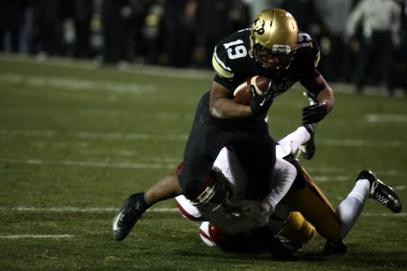 Michael Adkins II runs over a USC defender for a touchdown in the fourth quarter. (James Bradbury/CU Independent)