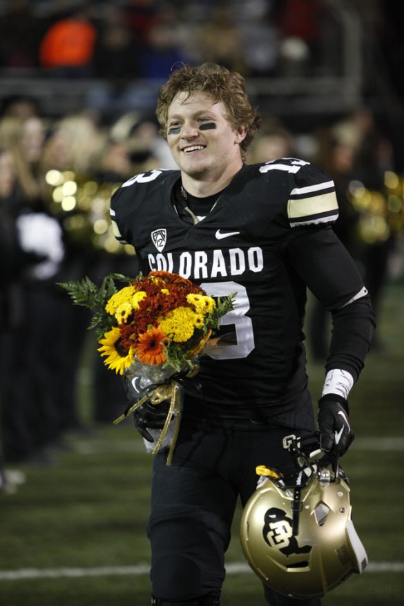 Senior defensive back Parker Orms (13) smiles as he runs onto the field during a senior ceremony. (Robert R. Denton/CU Independent)