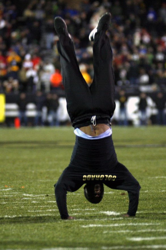 Ozell Williams does a back-hand-spring on the field during a timeout. Williams did 57 back-hand-springs in a row, setting a new world record. (Nate Bruzdzinski/CU Independent)