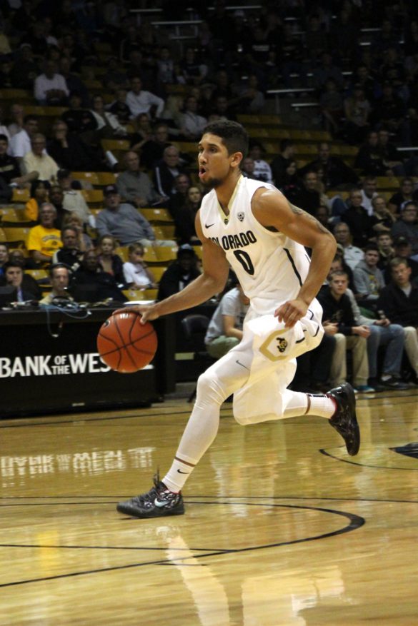 Guard Askia Booker (0) drives towards the hoop during the first half. (Gray Bender/CU Independent)