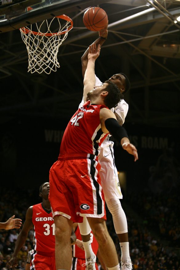Freshman Jaron Hopkins attempts a put-back dunk over Georgia's Nemanja Djurisic (42). Hopkins finished with five points in 18 minutes. (Kai Casey/CU Independent)
