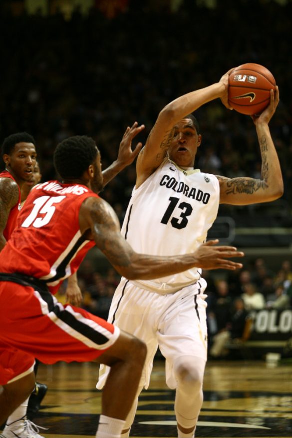 Freshman Dustin Thomas (13) controls the ball in front of Georgia's Donte' Williams (15). Thomas only played 10 minutes and finished with four points and four rebounds. (Kai Casey/CU Independent)