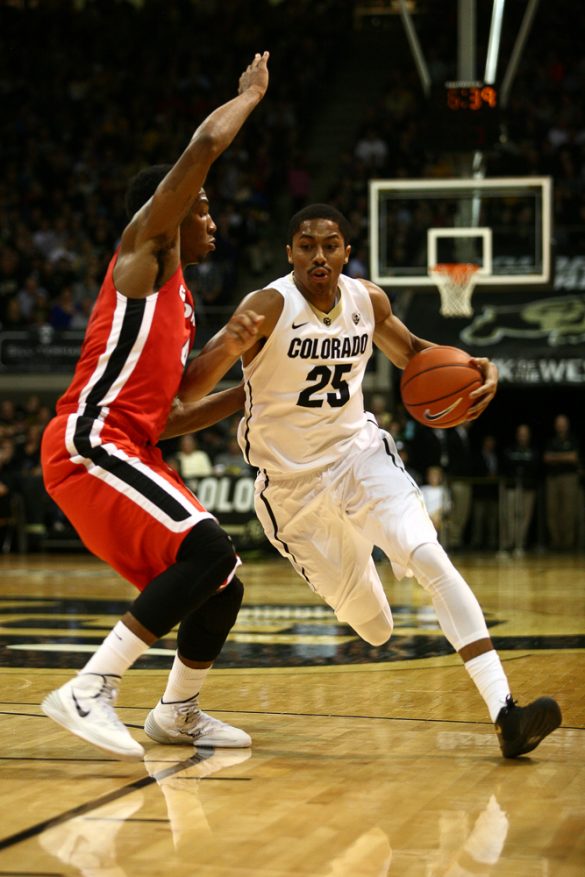 Junior guard Spencer Dinwiddie (25) drives into the lane against a Georgia defender. (Kai Casey/CU Independent)