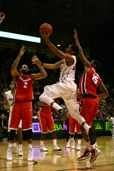 Colorado junior guard Spencer Dinwiddie (25) soars for a lay-up between Georgia's Donte' Williams (15) and Marcus Thornton (2). Dinwiddie had 17 points, second highest on the Buff squad that had five scorers in double digits. (Kai Casey/CU Independent)