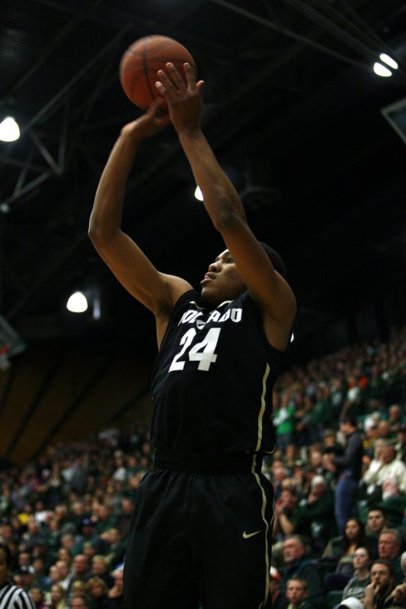 Freshman guard George King (24) shoots a 3-pointer. King had a quiet night, scoring zero points, but grabbing two rebounds in his six minutes of play. (Kai Casey/CU Independent)
