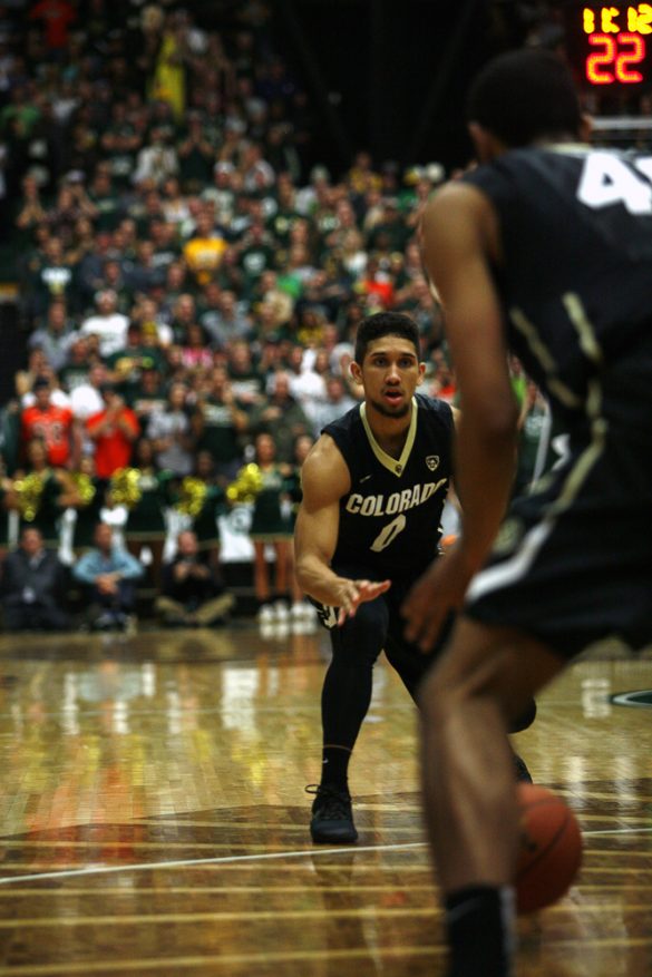 Junior guard Askia Booker (0) watches his pass to Josh Scott (40). The Buffs finished with nine assists. (Kai Casey/CU Independent)