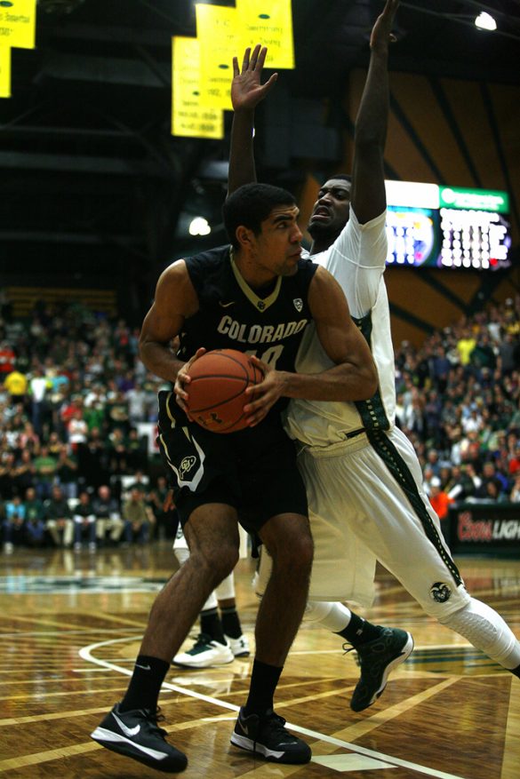 Sophomore forward Josh Scott (40) drives into CSU's Gerson Santo (15) in the second half. Scott had three blocks and seven rebounds in the game. (Kai Casey/CU Independent)