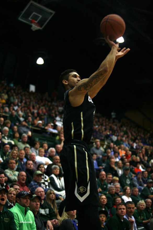 Junior guard Askia Booker (0) shoots a 3-pointer late in the game. (Kai Casey/CU Independent)