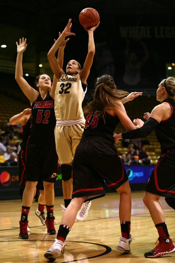 Colorado forward Arielle Roberson (32) shoots from under the basket while being defended by Brenna Gates (52). (Kai Casey/CU Independent)