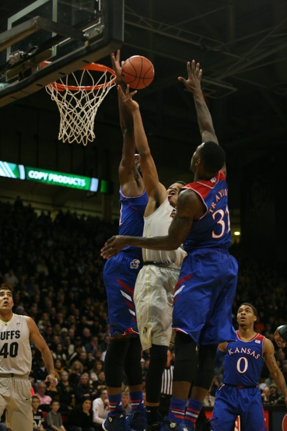 Askia Booker (0) splits Kansas defenders on his way to the rim during the first half. (Nate Bruzdzinski/CU Independent)