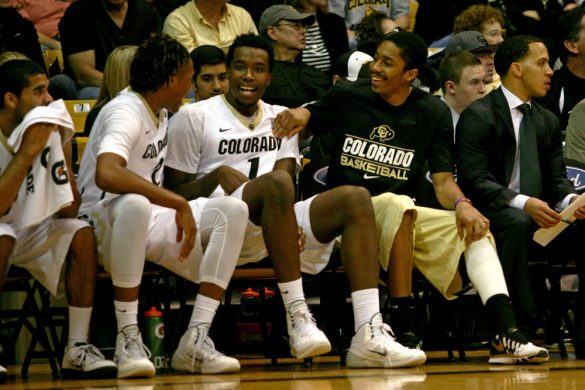 Out for the season with an injury, Spencer Dinwiddie jokes with a few teammates during the win against USC. (James Bradbury/CU Independent)