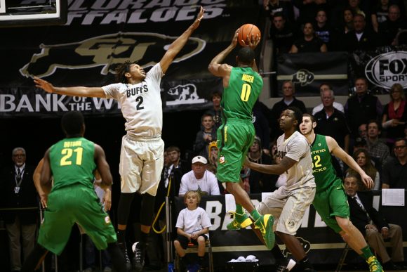 Colorado's Xavier Johnson (2) jumps to block a shot while Oregon's Mike Moser (0) passes. (Kai Casey/CU Independent)