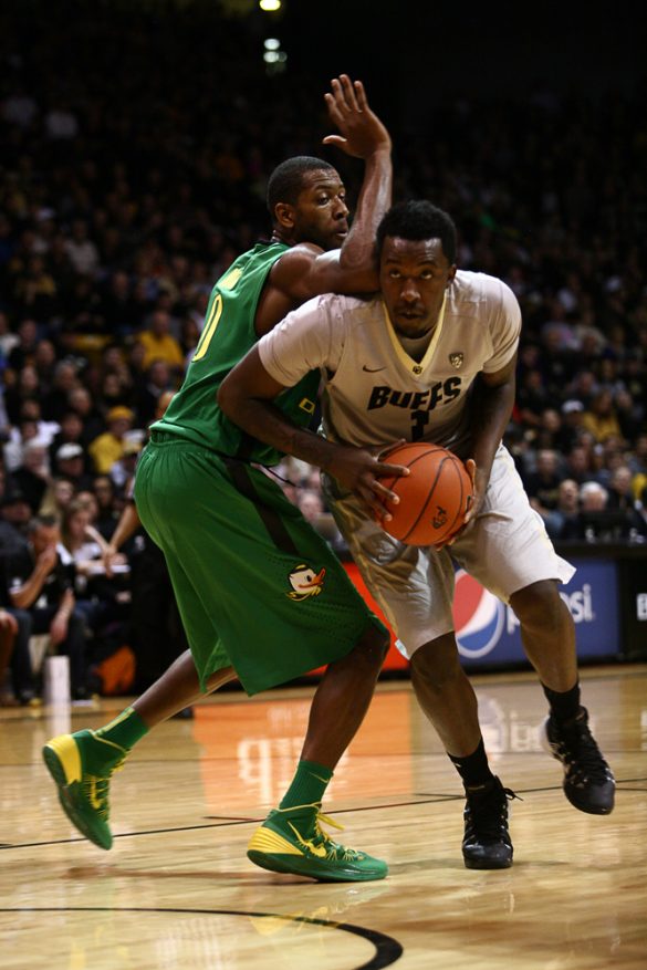 Colorado freshman forward Wesley Gordon (1) ducks under the arm of Oregon's Mike Moser (0) to drive to the hoop. (Kai Casey/CU Independent)