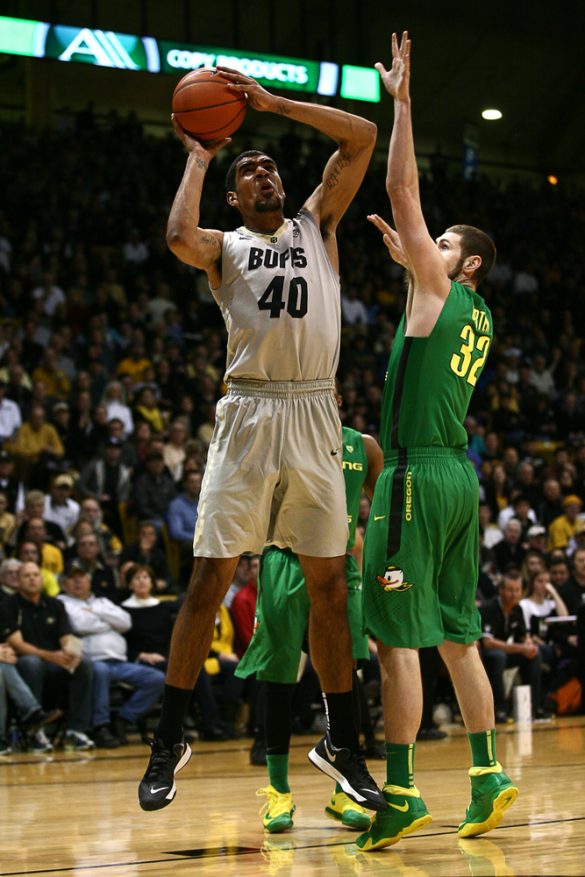 Colorado sophomore forward Josh Scott (40) protects the ball while going up for a jump shot against Oregon's Ben Carter (32). (Kai Casey/CU Independent)