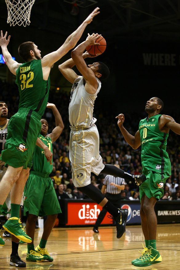 Colorado junior guard Spencer Dinwiddie (25) braces for contact while going up for a shot against Oregon's Ben Carter (32). (Kai Casey/CU Independent)