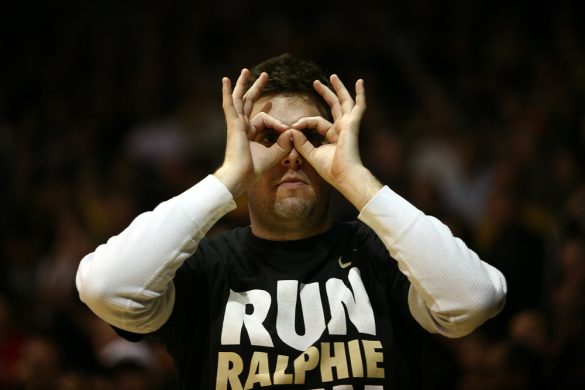 A Colorado fan wears "3 goggles" while celebrating a Colorado 3-pointer. (Kai Casey/CU Independent)