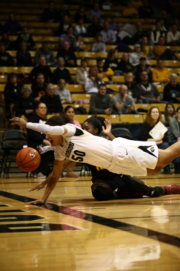 Colorado's Jamee Swan (50) and Arizona State's Promise Amukamara (10) dive for a loose ball before it goes out-of-bounds. (Kai Casey/CU Independent)