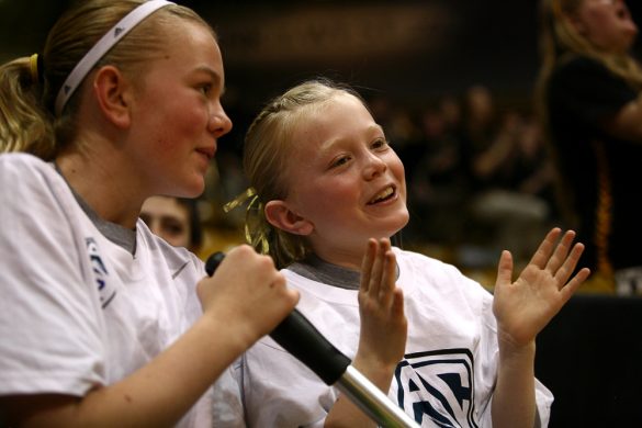 Pac-12 court shiner crew members smile as they cheer on Colorado. (Kai Casey/CU Independent)