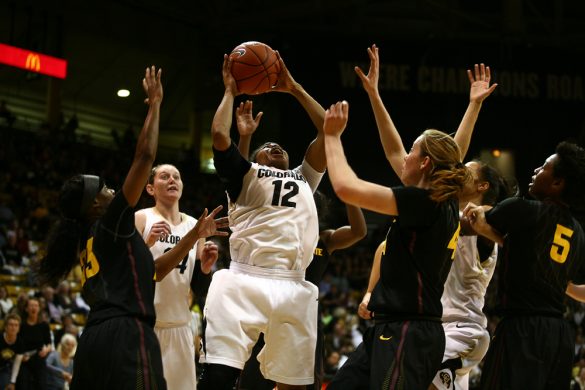 Colorado senior guard Ashley Wilson (12) grimaces as she goes back up for a layup after getting an offensive rebound. (Kai Casey/CU Independent)
