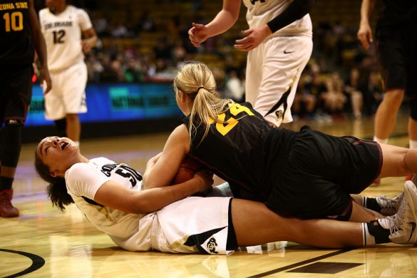 Colorado sophomore forward Jamee Swan (50) looks toward the referee while battling for a loose ball with Arizona State's Kelsey Moos (24). (Kai Casey/CU Independent)