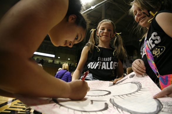 Colorado freshman forward Zoe Beard-Fails (31) signs autographs for Mariana Vadas-Arendt, 10 years old, left, and Megan Zingerman, 10. (Kai Casey/CU Independent)