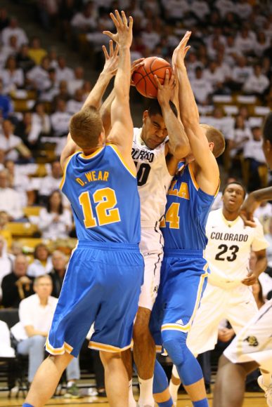 Looking to pass the ball, Josh Scott (40) gets sandwiched between UCLA defenders David Wear (12) and Travis Wear (24). (Nigel Amstock/CU Independent)