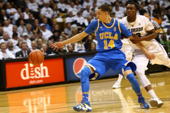 Jaron Hopkins (23) grabs the arm of UCLA guard Zack LaVine (14) to prevent him from receiving a pass. (Nigel Amstock/CU Independent)