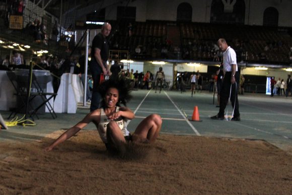 Redshirt sophomore Brittany Lewis lands in the sand during the long jump event, Saturday at the Potts Indoor Invitational in Balch Fieldhouse. She placed second, posting a distance of 5.71 meters. (Matt Sisneros/CU Independent)